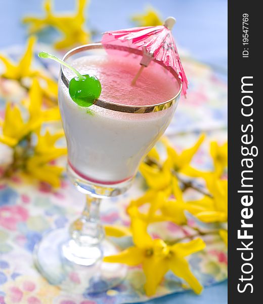 Vanilla milkshake with cherry garnish with shallow depth of field.