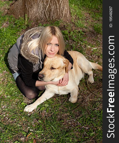 Outdoor shot of beautiful cheerful woman with dog in the park. Outdoor shot of beautiful cheerful woman with dog in the park