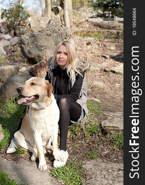 Outdoor shot of beautiful cheerful woman with dog in the park. Outdoor shot of beautiful cheerful woman with dog in the park