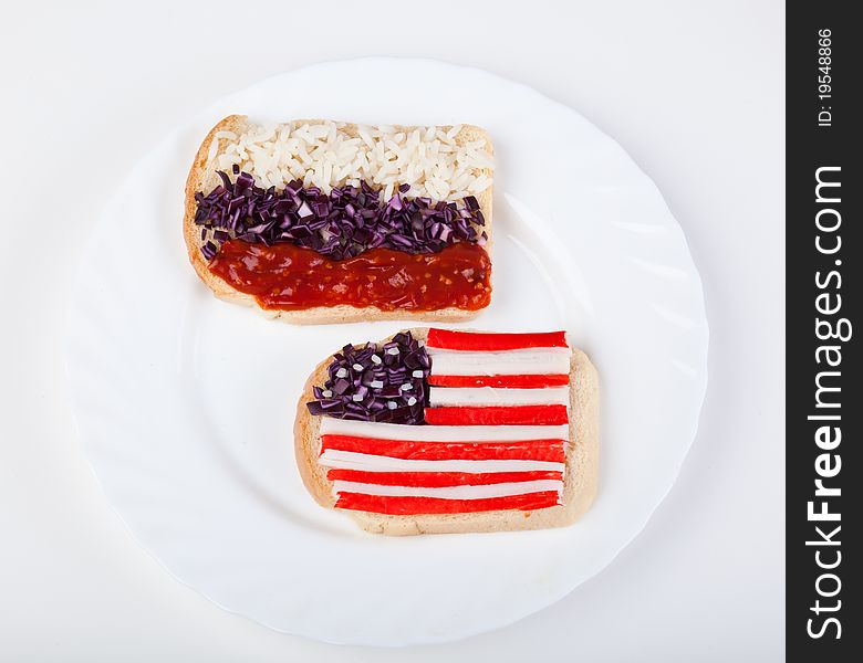 Sandwiches with flags of two countries on plate