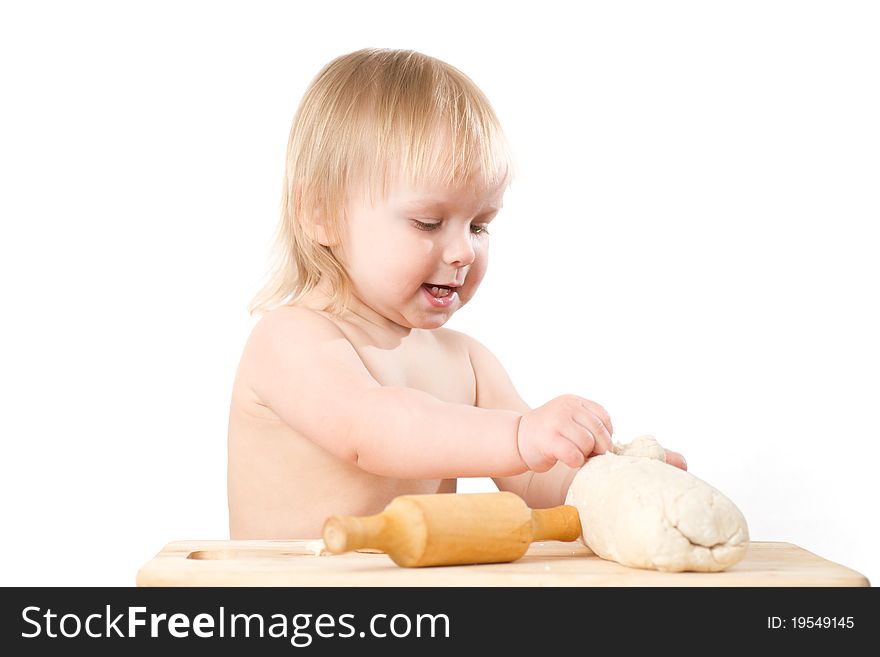 Adorable baby baking bread with rolling pin on white