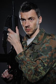 Young Soldier In Camouflage With A Gun Royalty Free Stock Image