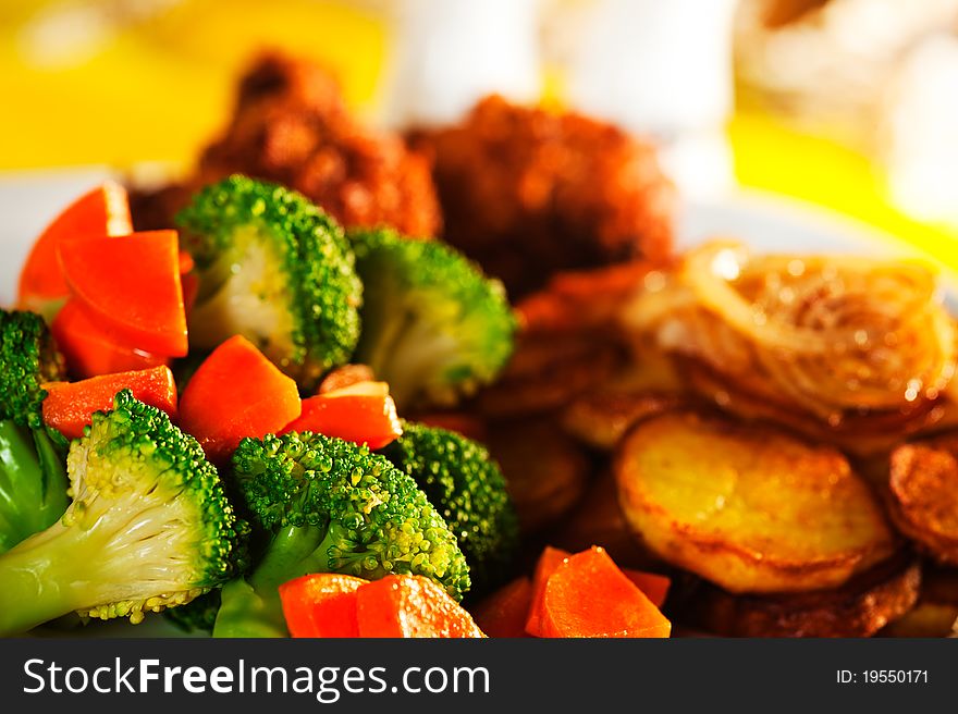 Fried potatoes broccoli carrots and roasted chicken. Fried potatoes broccoli carrots and roasted chicken