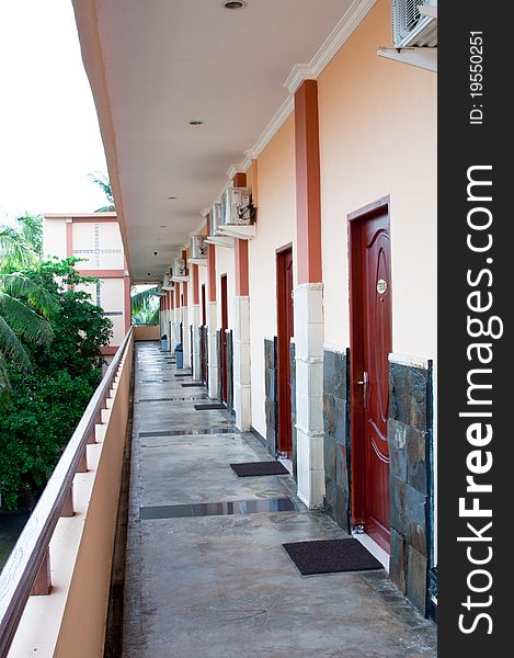 A portrait of hotel corridor with a long perspective view