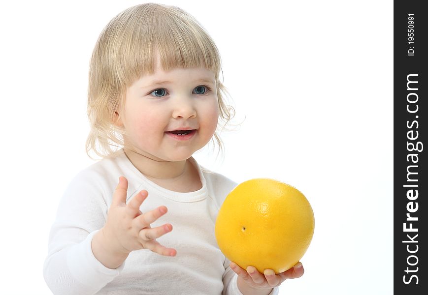 Baby with a ripe grapefruit isolated on white. Baby with a ripe grapefruit isolated on white