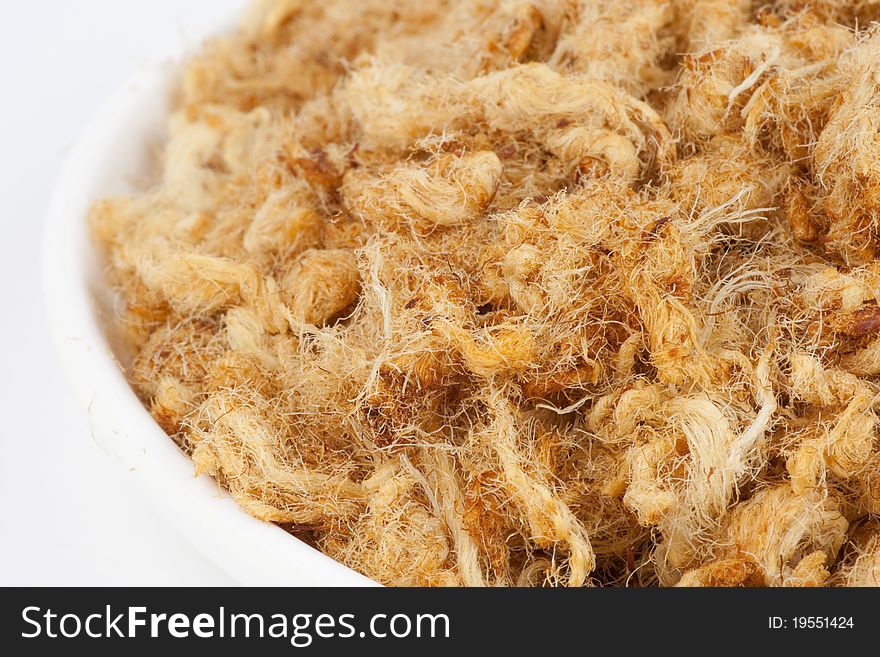 Shredded pork in a white bowl