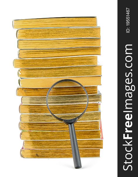A Stack Of Books And Magnifying Glass