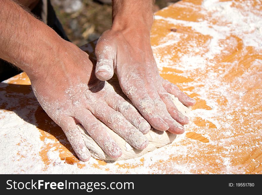 Man hands preparing a little bread