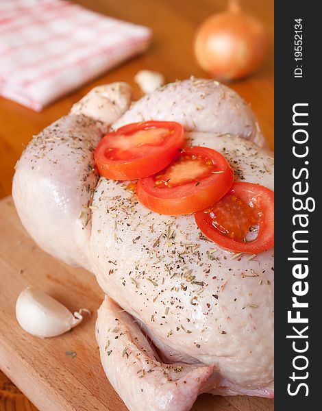 Preparation of a provencal chicken, with aromatic herbs, garlic, onions and tomatoes. Preparation of a provencal chicken, with aromatic herbs, garlic, onions and tomatoes
