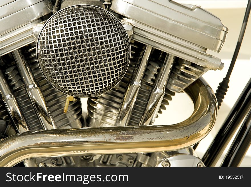 Motorcycle engine closeup showing cycliners, filter and exhaust