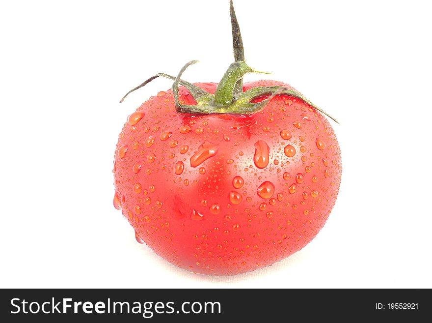 Red tomatoe with water drops isolated over white background.