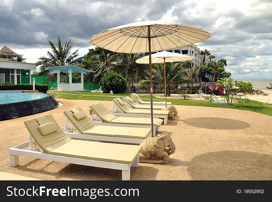 Beach chair on the beach with cloudy sky