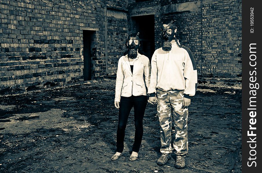 Bizarre portrait of romantic couple with gas masks