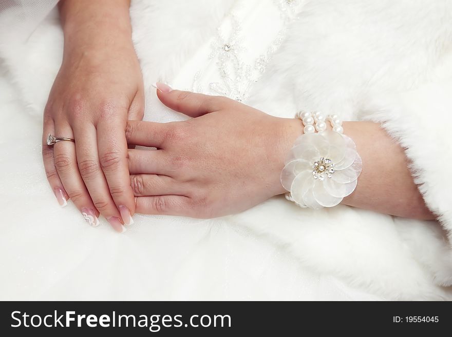 Bride's hands with ring and pearls