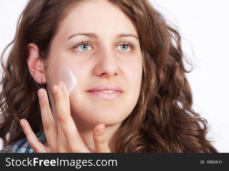 Beauty caucasian young woman applying moisture