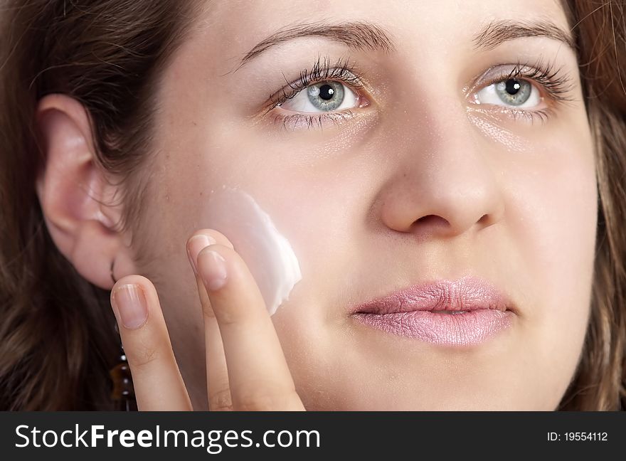 Beauty caucasian young woman applying moisture