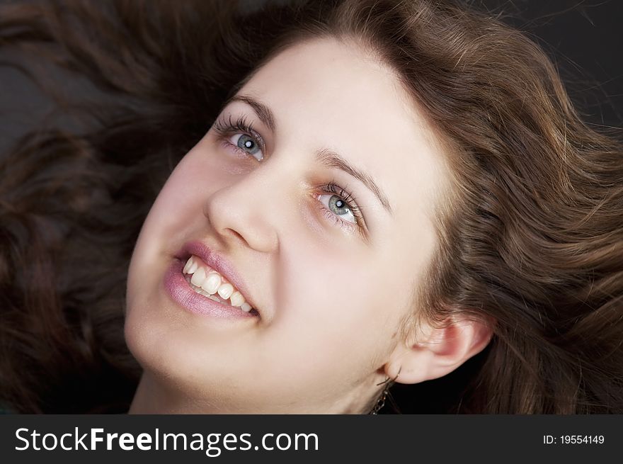 Young brunette woman with long flying hair, studio shot