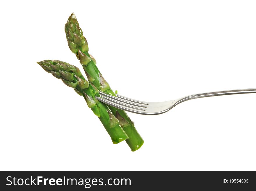 Two cooked asparagus spears on a fork isolated against white