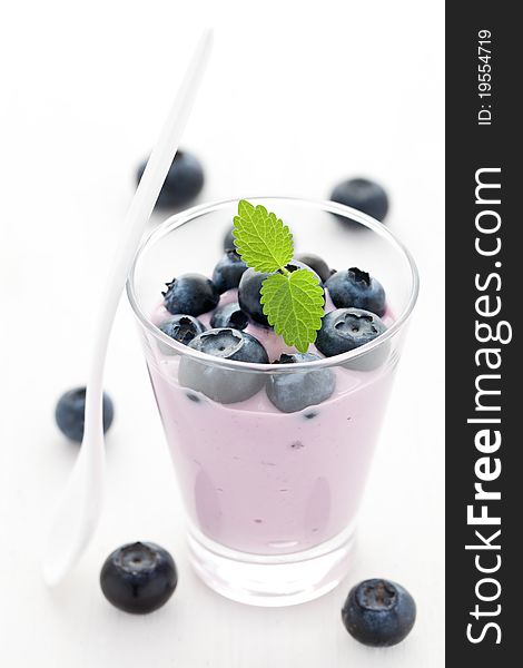 Fresh bilberry yogurt in a glass