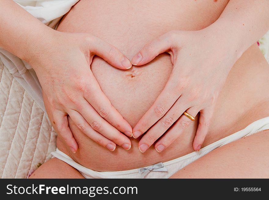 A pregnant girl on uniform background