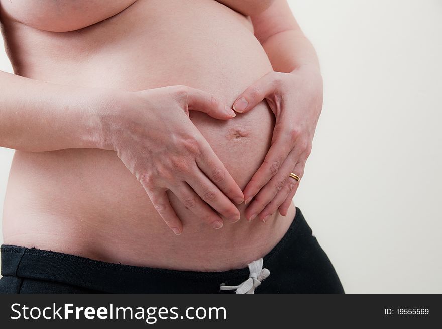 A pregnant girl on uniform background