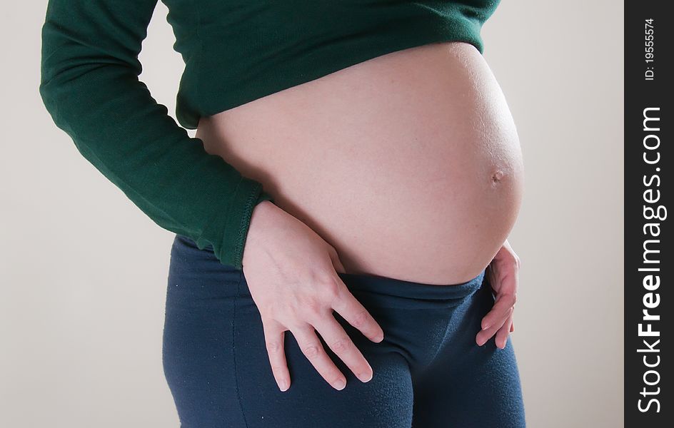 A pregnant girl on uniform background