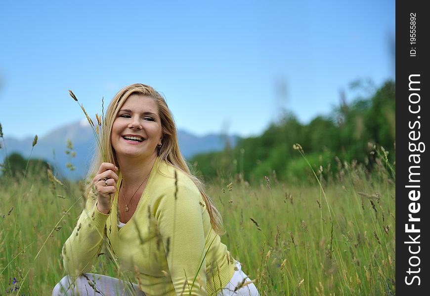 Beautiful natural woman with pure healthy skin outdoors on spring field. Switzerland. Beautiful natural woman with pure healthy skin outdoors on spring field. Switzerland