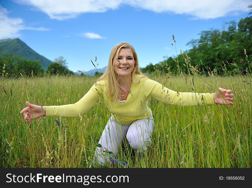 Pretty healthy summer woman on green field in Alps. Switzerland. Pretty healthy summer woman on green field in Alps. Switzerland