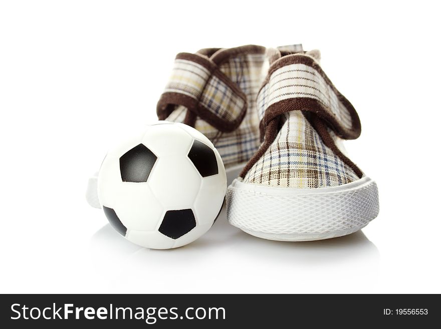 Children's shoes and a small soccer ball isolated on white background. Children's shoes and a small soccer ball isolated on white background