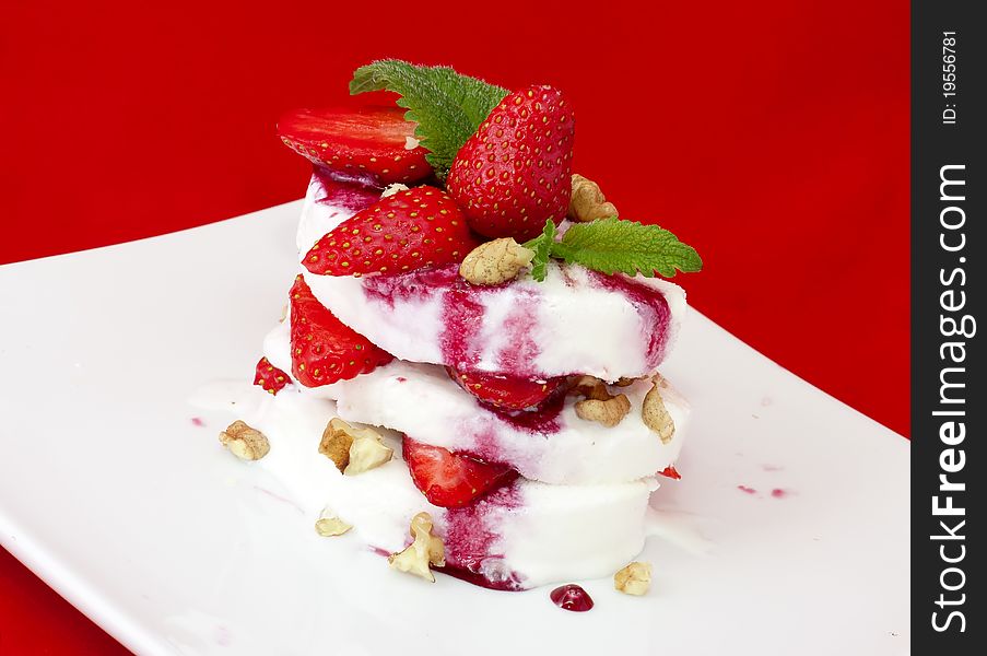 Slices of ice cream with strawberry over red