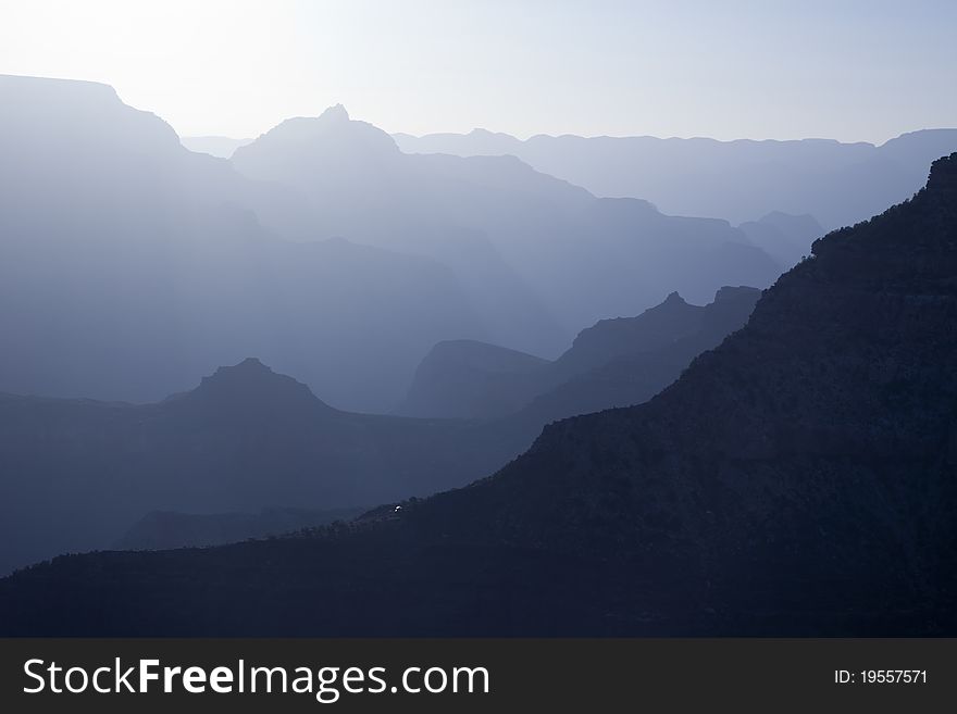 Scenic Layers of the Grand Canyon in the Early Morning with Hikers Cabin Roof Shining in the Lower Middle.