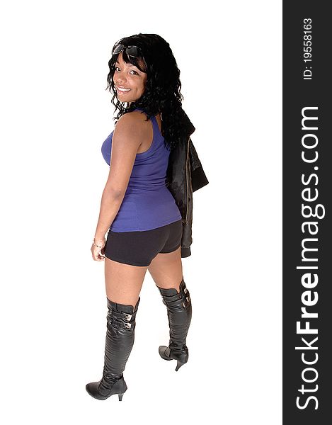 A pretty African American woman in shorts, a leather jacket and boots, standing from the back, for white background. A pretty African American woman in shorts, a leather jacket and boots, standing from the back, for white background.