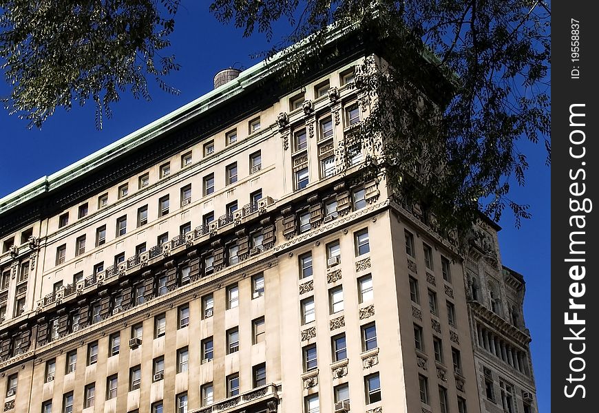 A corner of the building in Manhattan, New York against the deep blue sky.