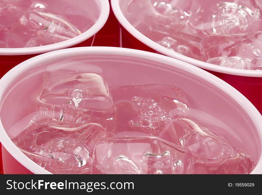 Water and ice in a red disposable cup. Water and ice in a red disposable cup.