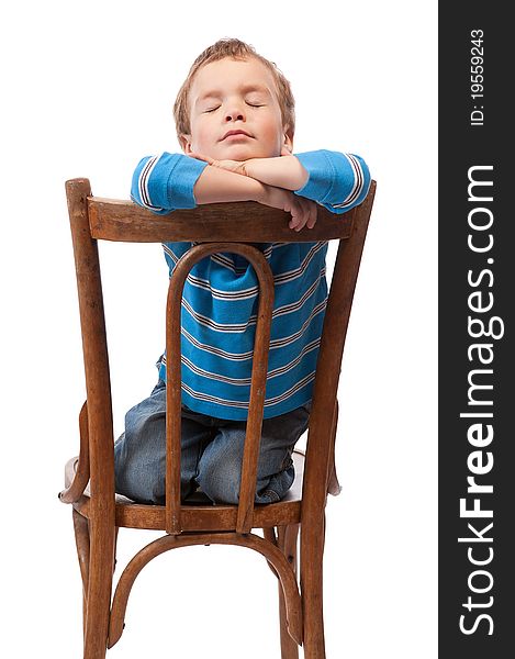 Little boy sits in chair with his eyes closed, isolation. Little boy sits in chair with his eyes closed, isolation