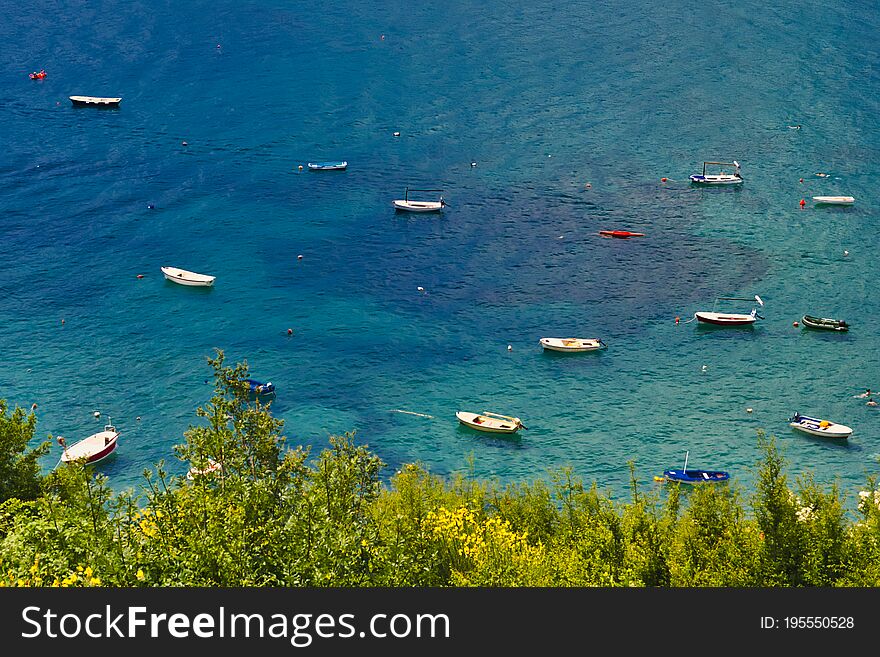 Blue bay with boats and trees on a foreground. Blue bay with boats and trees on a foreground