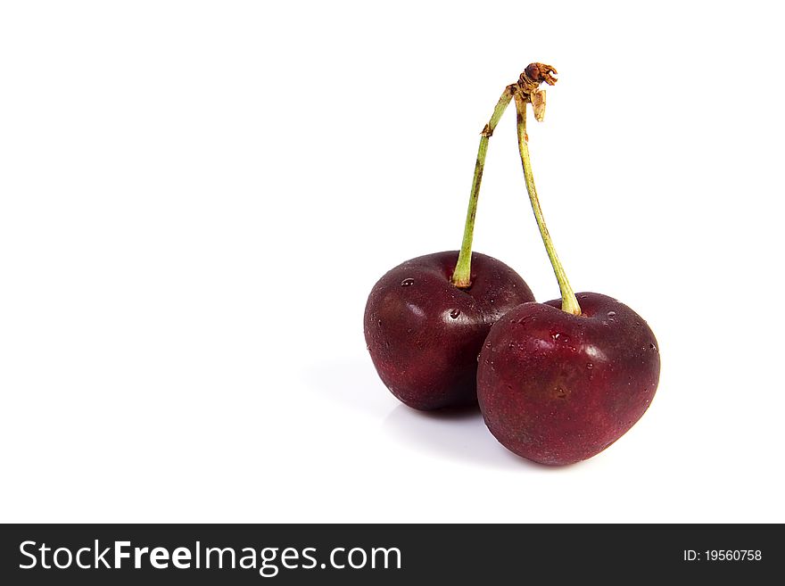 Two cherries with dewdrop on white background