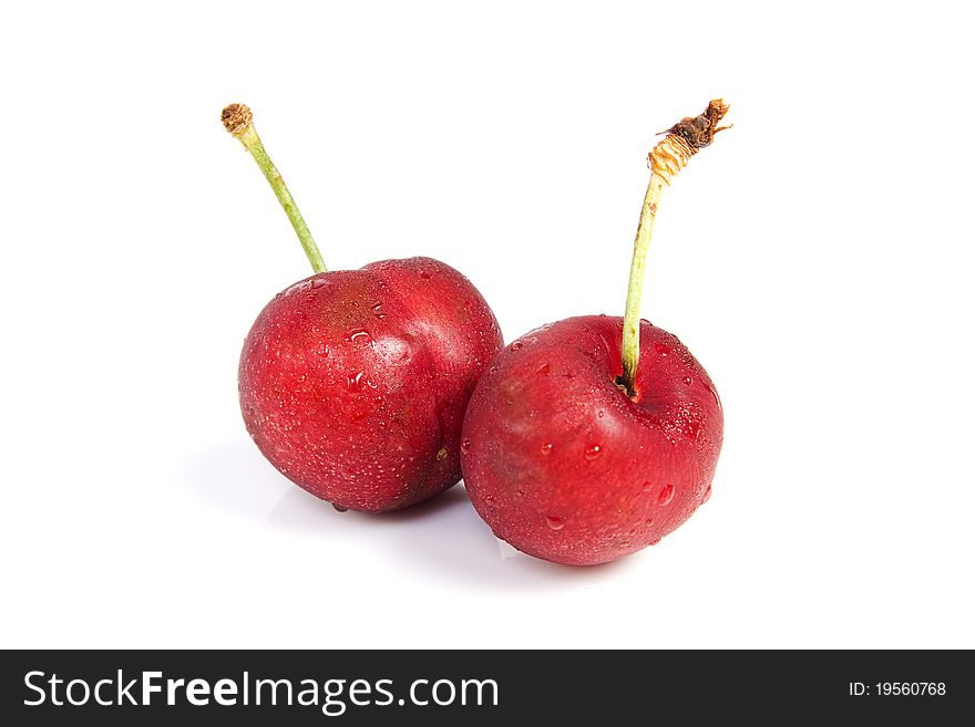 Two cherries with dewdrop on white background