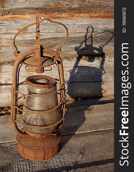 The old kerosene lamp on the background wall of a village house. The old kerosene lamp on the background wall of a village house