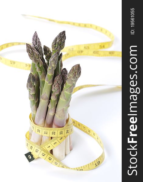 Raw asparagus and measuring type isolated on a white background