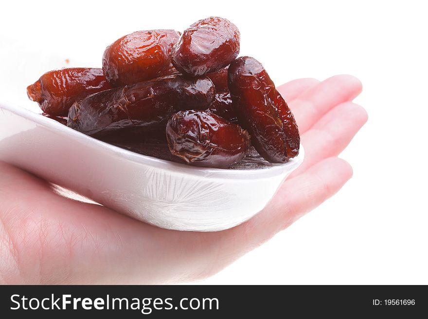 Dried date fruits in hand isolated on white background. Dried date fruits in hand isolated on white background