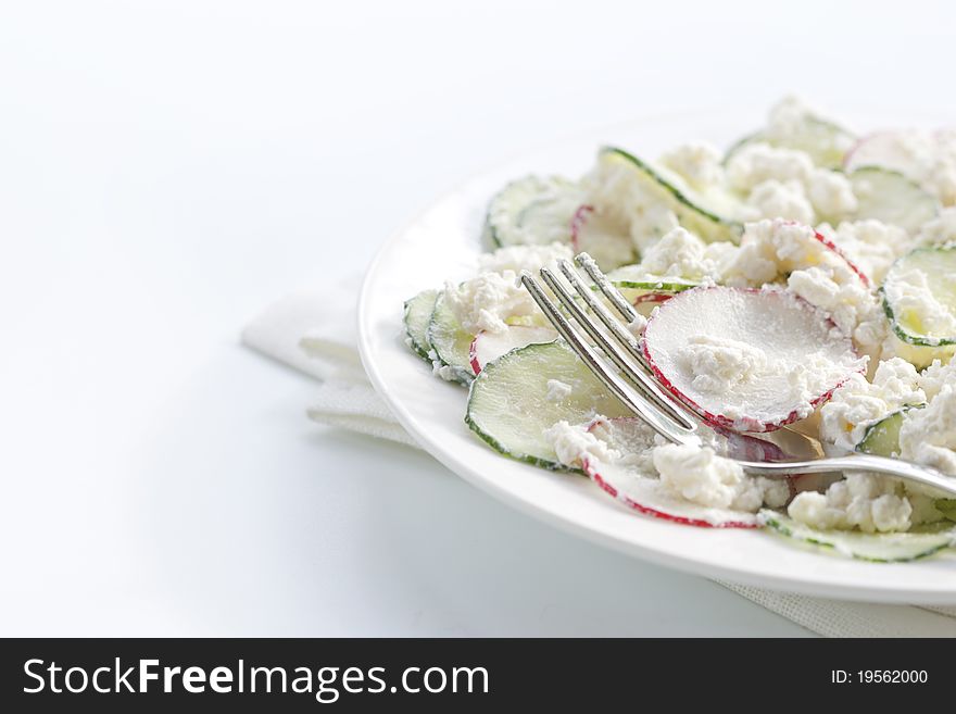 Fresh radish salad with cucumber and cheese