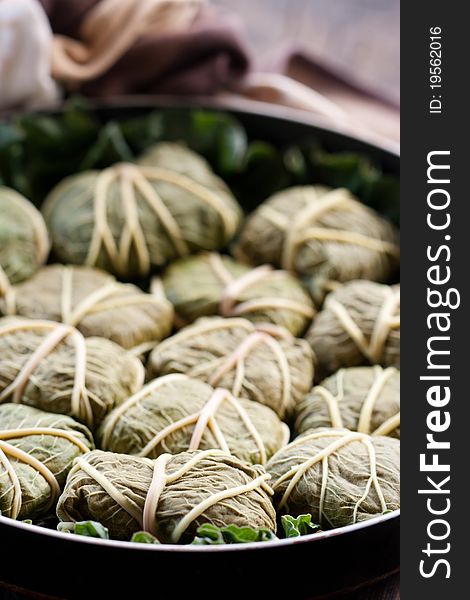 Rustic food, armenian or greek dolmades wrapped with rhubarb leaves, meat and rice. Rustic food, armenian or greek dolmades wrapped with rhubarb leaves, meat and rice