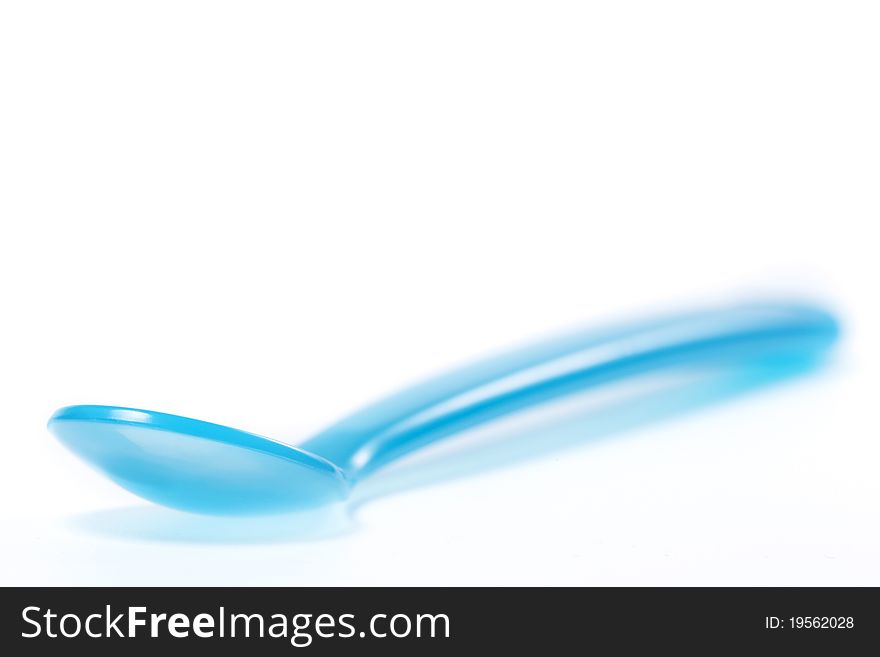 Blue plastic spoon on white background