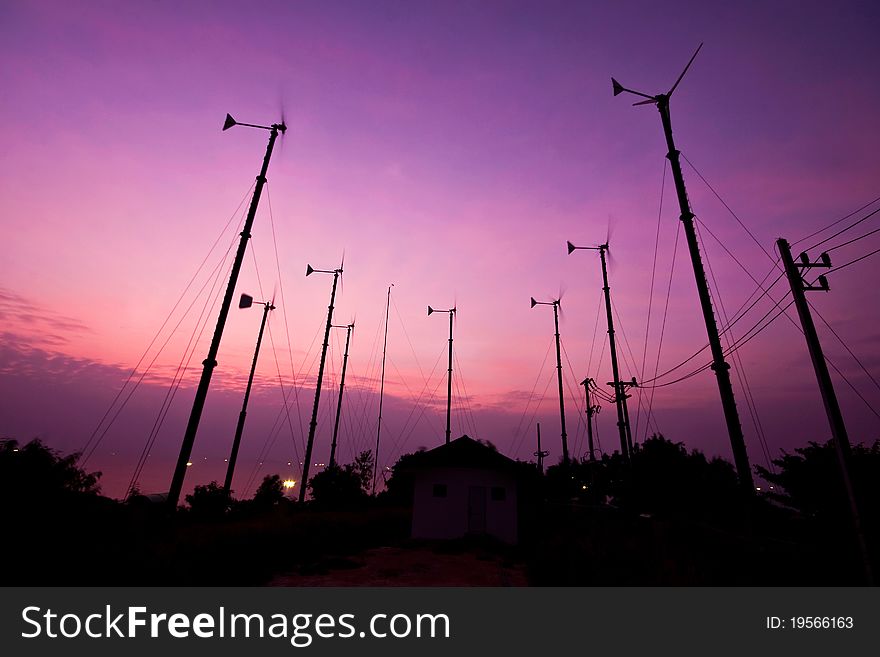 Silhouette turbine wind mill in sunset background