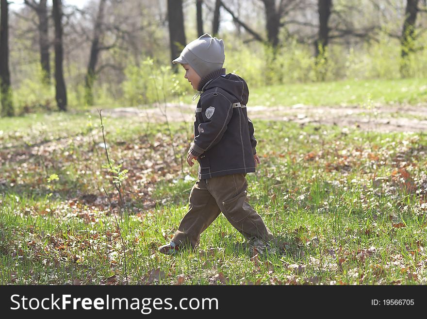 The little boy walks on wood. The little boy walks on wood