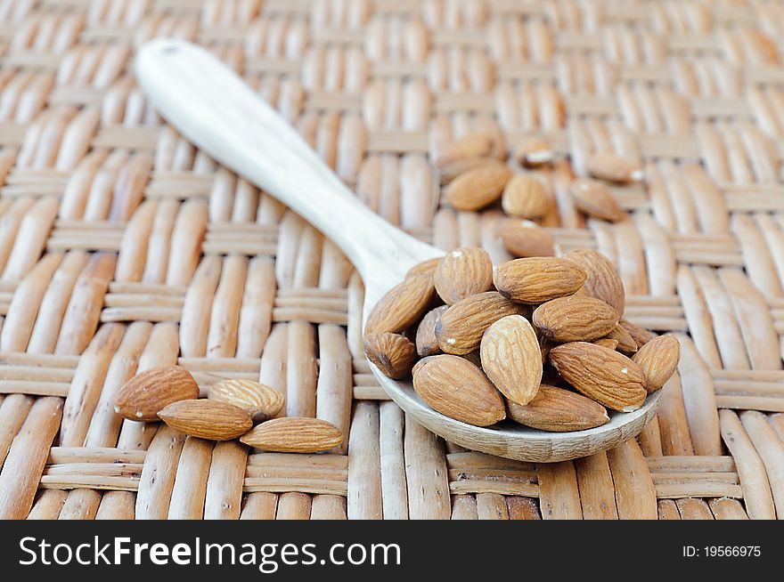 Tasty nuts of almond on the wooden spoon. Tasty nuts of almond on the wooden spoon