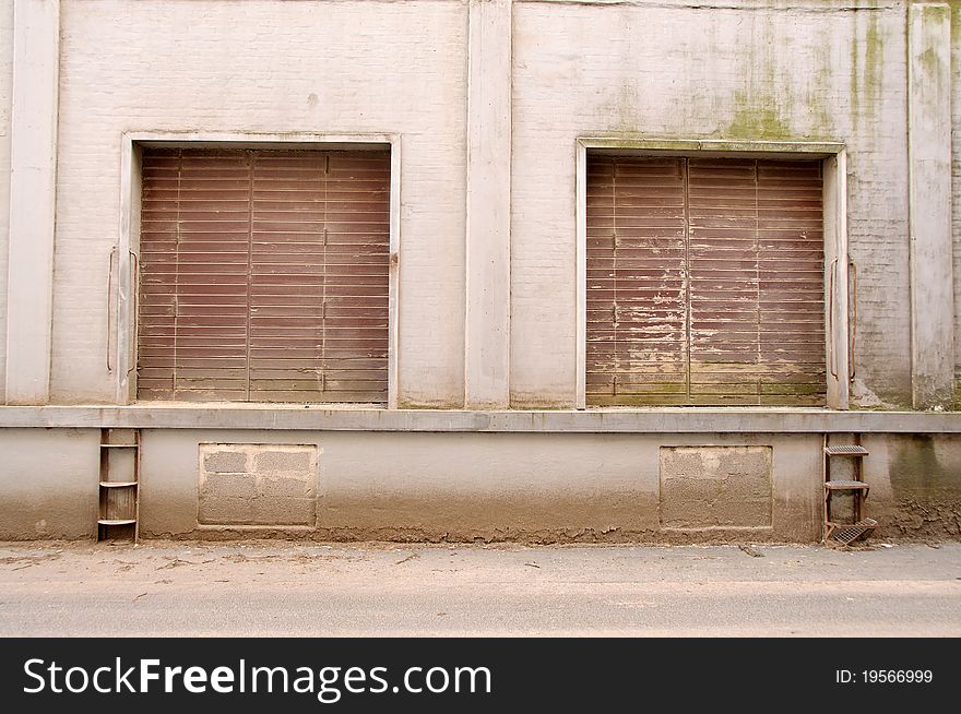 Two dusty gates placed in building in harbour area. Two dusty gates placed in building in harbour area