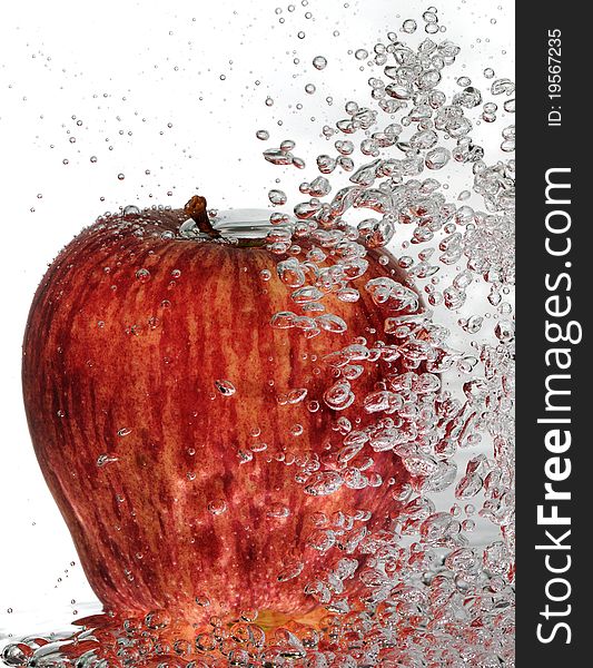 A ripe, red delicious apple with rising water bubbles. A ripe, red delicious apple with rising water bubbles.