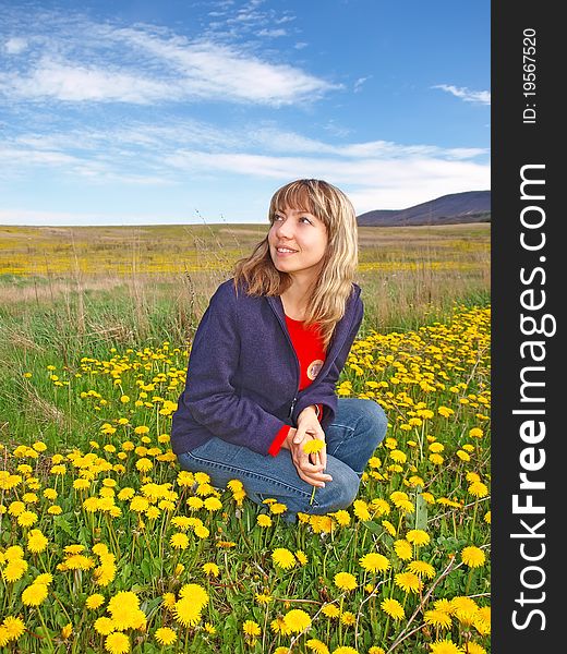 Beautiful Girl On A Dandelions Field